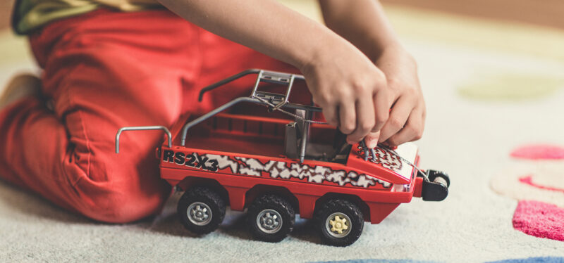 Child playing with car