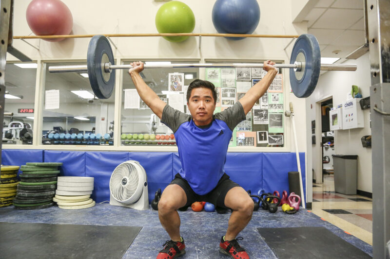 A person lifting weights in a training session